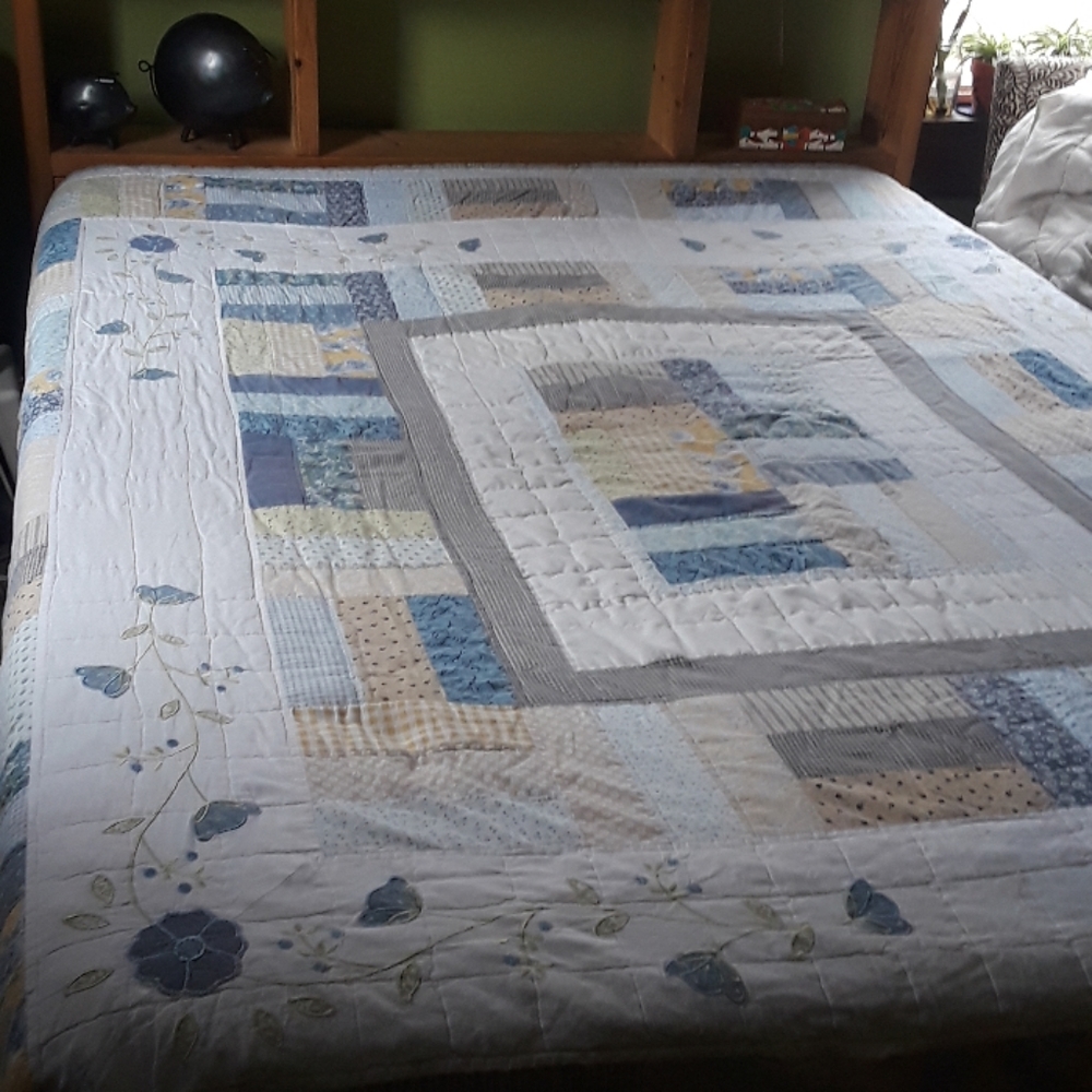Beautiful hand sewn quilt with floral embroidery